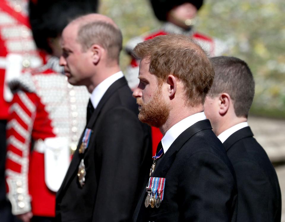 Prince William (left) and Prince Harry follow the coffin during the ceremonial funeral procession for their grandfather, Prince Philip.