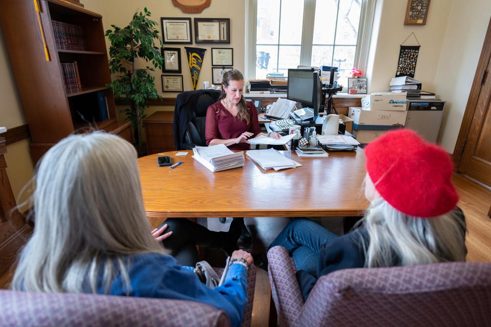 Pueblo City Clerk Marisa Stoller, center, looks over petitions with anti-mayor organizers Susan Carr and Judalon Smyth, right, on Wednesday, March 29, 2023.