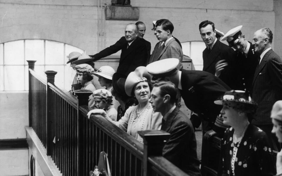 Princess Elizabeth (third from left), with King George VI (1895 - 1952), Lord Louis Mountbatten (1900 - 1979, standing, third from right) and Queen Elizabeth, the Queen Mother (1900 - 2002) during a visit to the chapel at the Royal Naval College, Dartmouth, 23rd July 1939. 