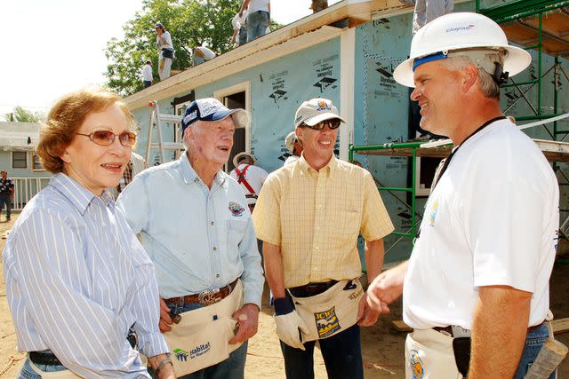 <p>R. Diamond/WireImage</p> Rosalynn, Jimmy and Jeff Carter speak with the then-Lowe's CEO Robert Niblock at a Habitat for Humanity worksite