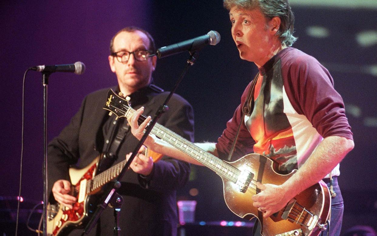 Elvis Costello playing with Paul McCartney, in 1999