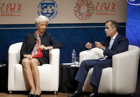 International Monetary Fund (IMF) Managing Director Christine Lagarde (L) and Bank of England's Governor Mark Carney attend the "Debate on the Global Economy" session during the 2015 IMF/World Bank Annual Meetings in Lima, Peru, October 8, 2015. REUTERS/Guadalupe Pardo