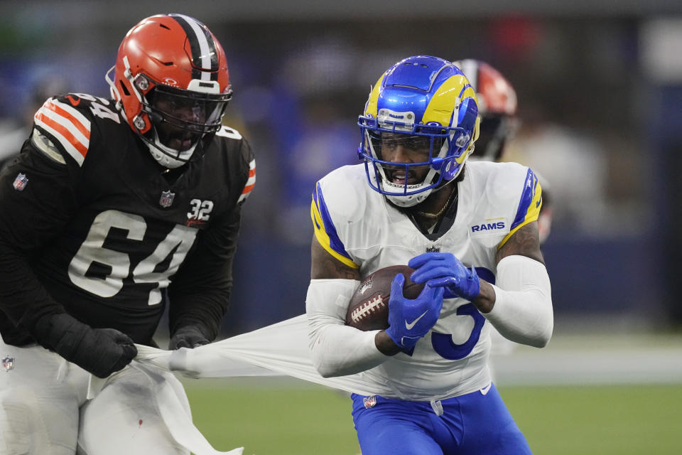 Los Angeles Rams safety John Johnson III (43) his his jersey pulled by Cleveland Browns offensive tackle Geron Christian (64) as Johnson III runs back with an intercepted pass during the second half of an NFL football game Sunday, Dec. 3, 2023, in Inglewood, Calif. (AP Photo/Mark J. Terrill)