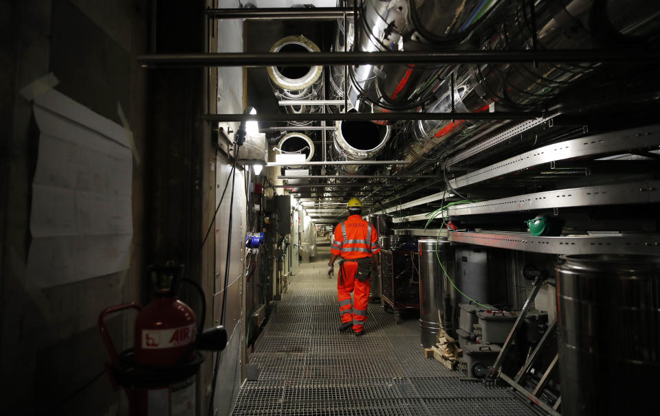 A worker walks in an undersea tunnel part of a plan to protect the city of Venice from flooding, in Venice, Italy, Friday, Nov. 29, 2019. The barrier system is made up of 78 giant flood gates, each 20 meters long which are attached by hinges to giant cement blocks placed on the seabed along the three openings from the sea into the lagoon, Malamocco, Chioggia and the Lido. (AP Photo/Antonio Calanni)