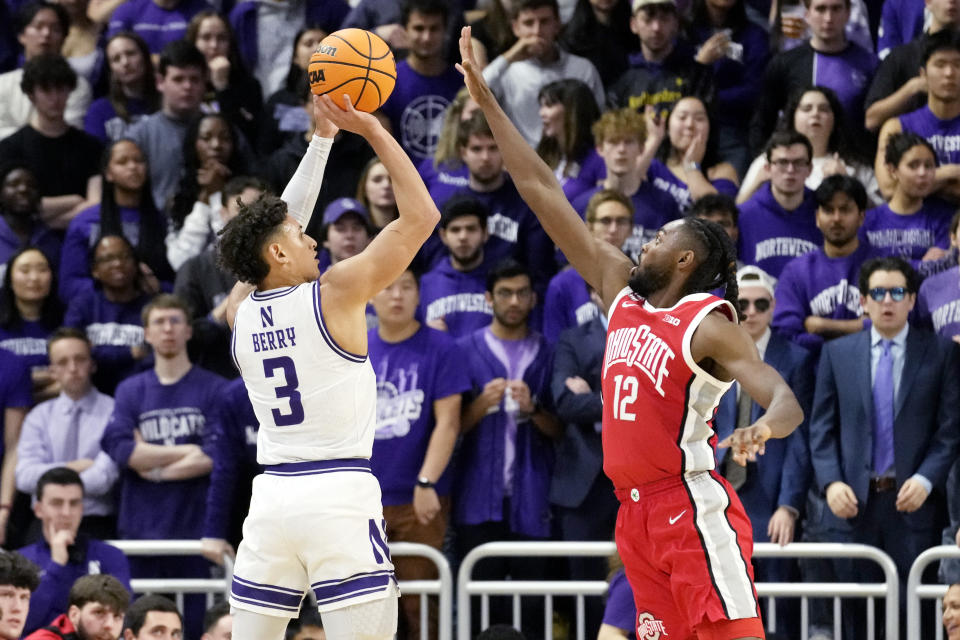 Northwestern guard Ty Berry, left, shoots against Ohio State guard Evan Mahaffey, right, during the first half of an NCAA college basketball game in Evanston, Ill., Saturday, Jan. 27, 2024. (AP Photo/Nam Y. Huh)