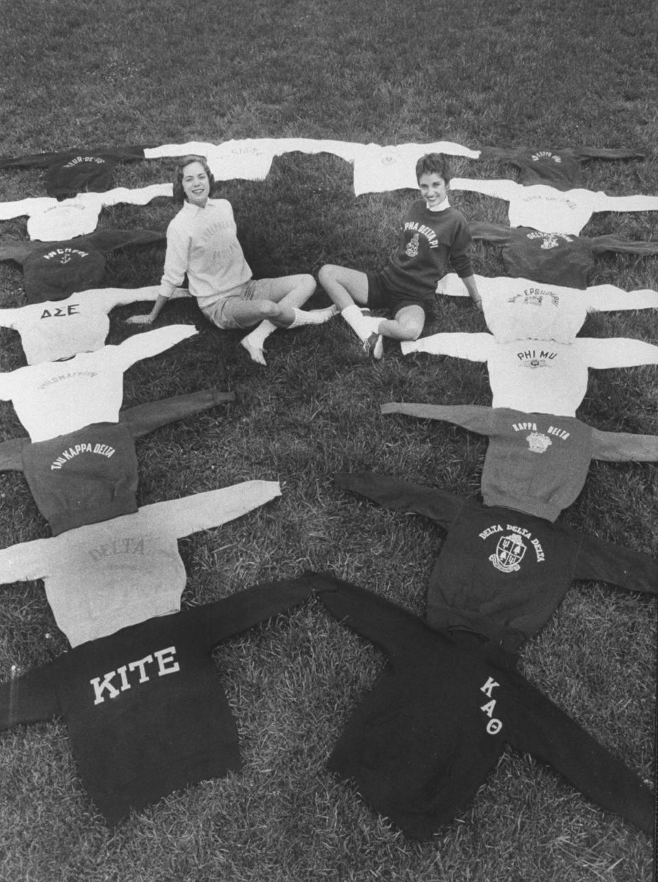 Vintage photo of young women posing with different sorority sweatshirts