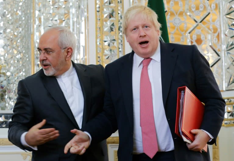 Iranian Foreign Minister Mohammad Javad Zarif (L) shakes hands with his British counterpart Boris Johnson during a meeting in Tehran on December 9, 2017