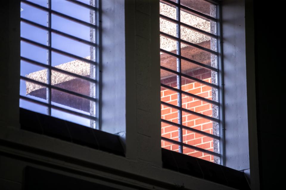 Light shines on the brick of the Oakdale Prison in Coralville in 2019. A new study led by a University of Iowa researcher has found that being incarcerated speeds up the aging process.