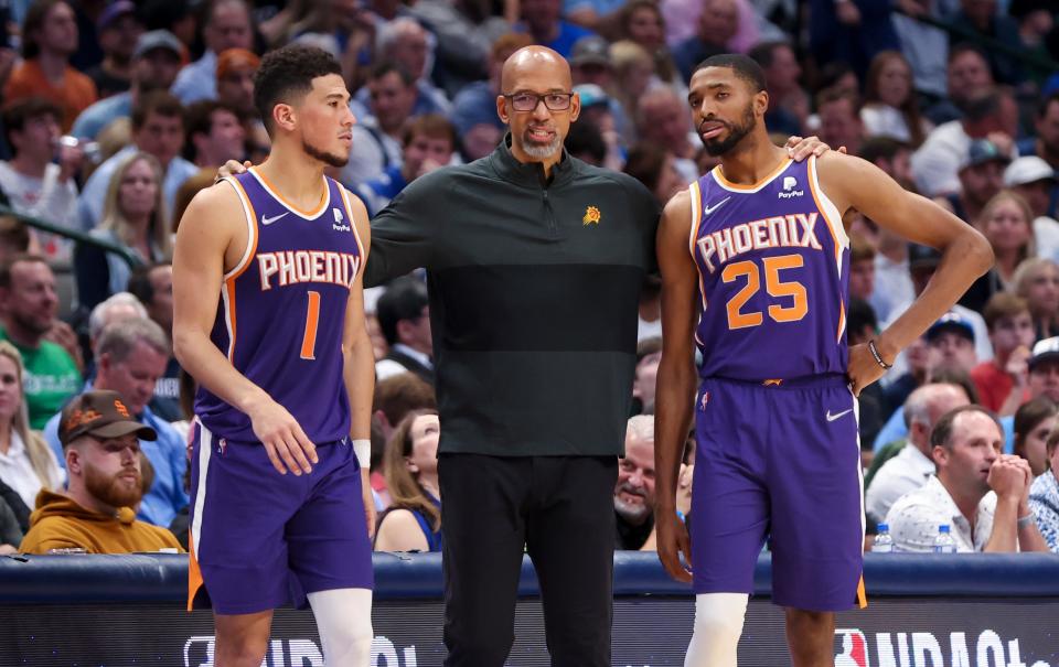 Phoenix Suns head coach Monty Williams speaks with Phoenix Suns guard Devin Booker (1) and forward Mikal Bridges (25) during Game 3 against the Dallas Mavericks in the conference semifinals at American Airlines Center, May 6, 2022 in Dallas.