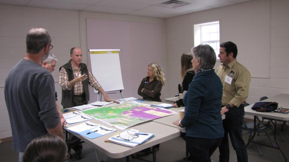 Don Barger, southeast regional director for National Parks Conservation Association from 1992 to 2019, hired Jeff Hunter in 2015 to work with multiple federal and state agencies and with regional conservation allies to preserve wildlife connectivity in the Southern Appalachian region. Barger is shown here leading a small group discussion at a 2018 stakeholder group meeting of the Pigeon River Gorge collaborative, which was later named Safe Passage.