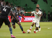 Austin FC midfielder Daniel Pereira, right, drives toward the goal against LA Galaxy midfielder Rayan Raveloson, left, during the first half of an MLS soccer match, Sunday, Sept. 26, 2021, in Austin, Texas. (AP Photo/Michael Thomas)