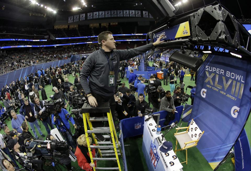 Jeremy Krug changes a sign as the Seattle Seahawks get ready to start their media day for the NFL Super Bowl XLVIII football game Tuesday, Jan. 28, 2014, in Newark, N.J. (AP Photo/Charlie Riedel)