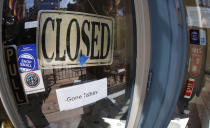 FILE - In this Thursday, June 18, 2020, file photo, a closed sign hangs in the door of The Market, a long-time restaurant and food store located in Larimer Square, that has closed because of the new coronavirus, in downtown Denver. State governments are pushing for help from Congress to fix budget gaps caused by the coronavirus pandemic and economic shutdowns. (AP Photo/David Zalubowski, File)