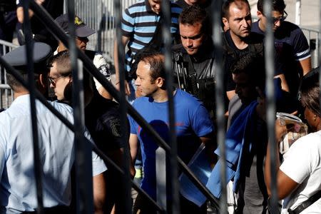 One of the eight Turkish soldiers (C), who fled to Greece in a helicopter and requested political asylum after a failed military coup against the government, is escorted by special police forces after the postponement of their interviews for asylum request at the Asylum Service in Athens, Greece, July 27, 2016. REUTERS/Alkis Konstantinidis