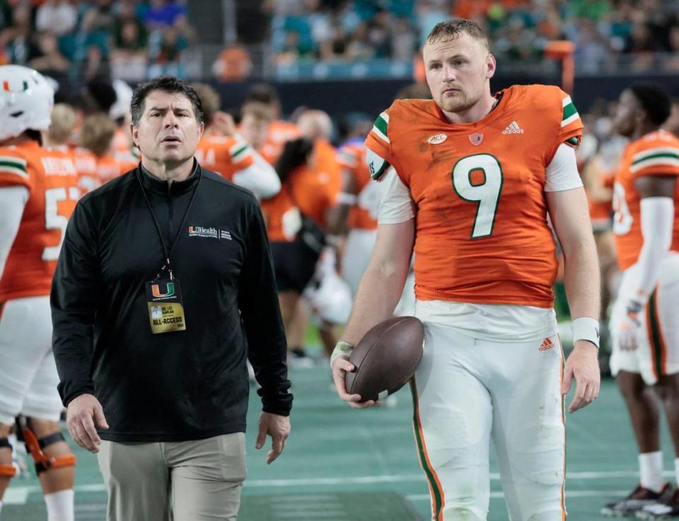 Miami Hurricanes quarterback Tyler Van Dyke (9) walks with Dr. Lee Kaplan on the sidelines in the second quarter at Hard Rock Stadium in Miami Gardens on Saturday, November 26, 2022.