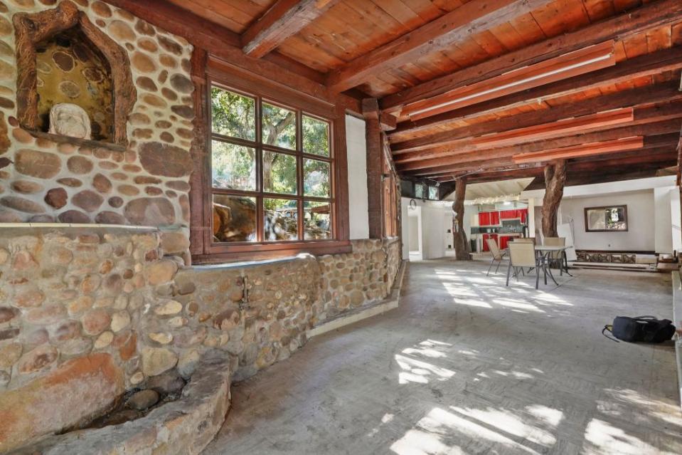 Despite the apparent state, handsome features remain, such as stone walls and wood-beamed ceilings. Holly & Chris Luxury Homes Group, Coldwell, Banker Calabasas