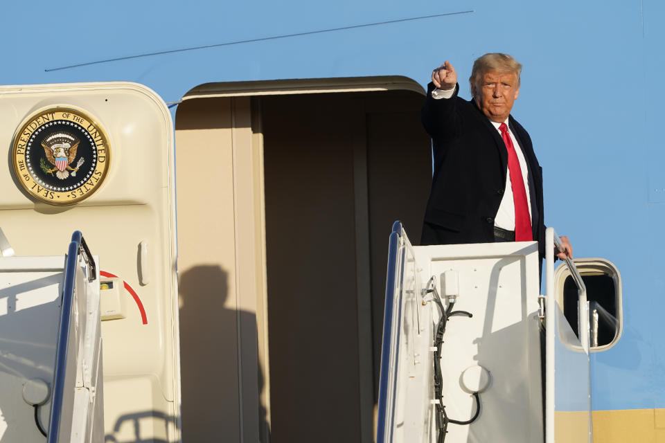 President Donald Trump gestures from the top of the steps of Air Force One at Andrews Air Force Base, Md., Wednesday, Oct. 21, 2020. Trump is heading to North Carolina for a campaign rally. (AP Photo/Susan Walsh)