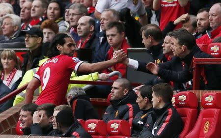 Manchester United's Radamel Falcao shakes hands with manager Louis van Gaal after being substituted. Reuters / Phil Noble