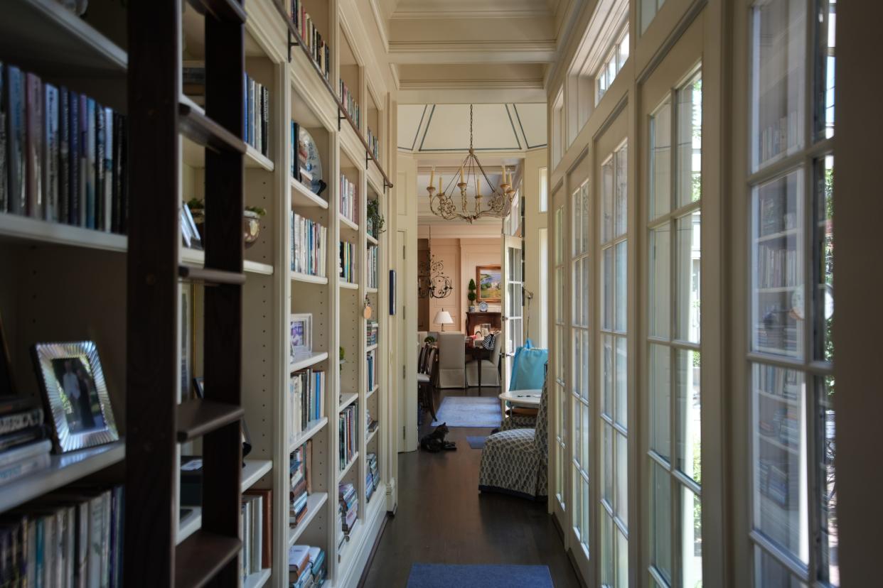 As part of the many renovations in the McDonald home, a walkway with a bookshelf and elephant ladder join each side of the house together in a modern hallway.