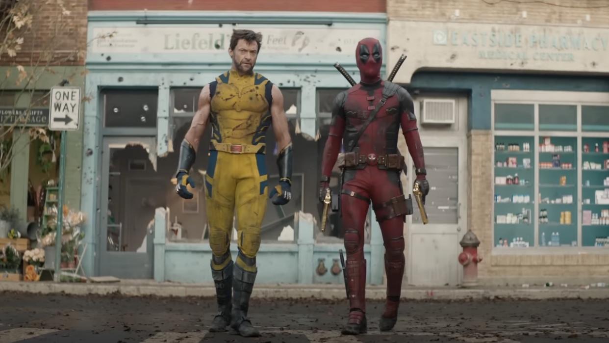  Hugh Jackman's Wolverine and Ryan Reynolds' Deadpool walking through torn-apart street. 