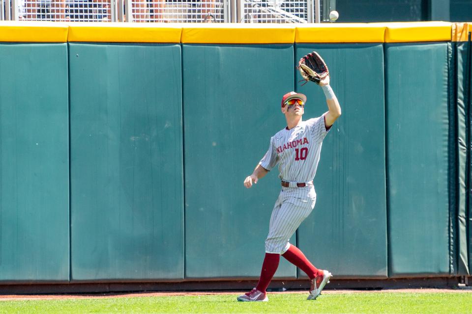 Jun 26, 2022; Omaha, NE, USA; Oklahoma Sooners center fielder Tanner Tredaway (10) makes an out against the Ole Miss Rebels during the third inning at Charles Schwab Field. Mandatory Credit: Dylan Widger-USA TODAY Sports