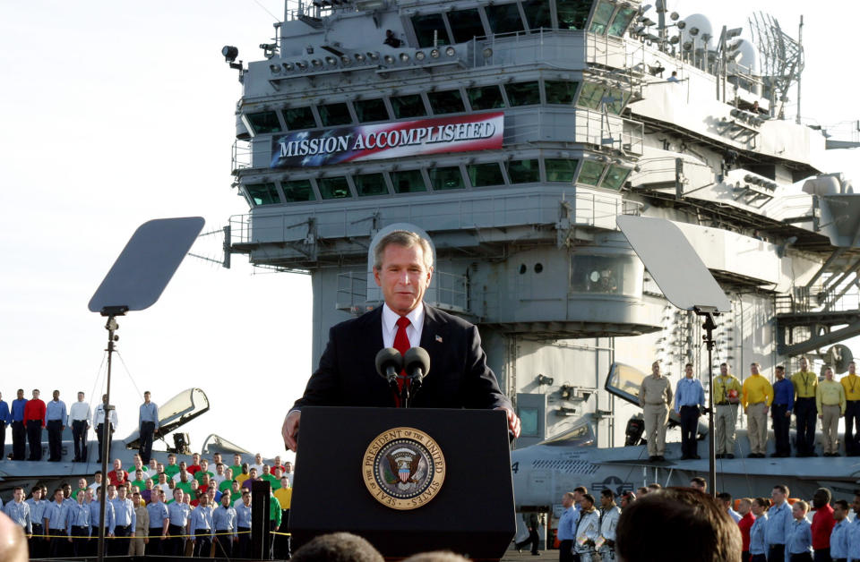 FILE - President Bush declares the end of major combat in Iraq as he speaks aboard the aircraft carrier USS Abraham Lincoln off the California coast, in this May 1, 2003 file photo. The former Soviet Union marched into Afghanistan on Christmas Eve, 1979, claiming it was invited by the new Afghan communist leader, Babrak Karmal, setting the country on a path of 40 years of seemingly endless wars and conflict. After the Soviets left in humiliation, America was the next great power to wade in. (AP Photo/J. Scott Applewhite, File)