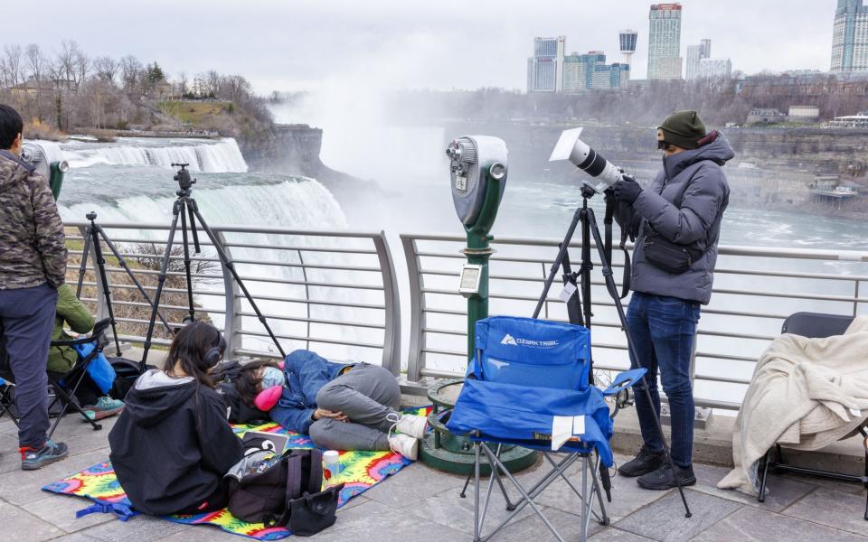 People camp out at Prospect Point hours before the total solar eclipse at Niagara Falls