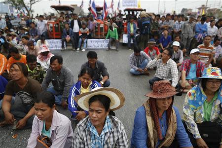 Rice farmers listen to a leader's speech on a highway where they spent a night among their tractors in Ayutthaya province February 21, 2014. REUTERS/Damir Sagolj