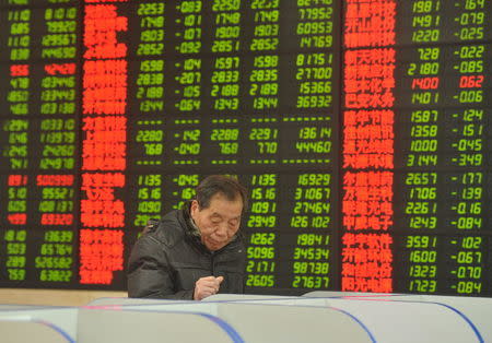 An investor looks at a computer screen showing stock information at a brokerage house in Fuyang, Anhui province, January 28, 2016. REUTERS/China Daily