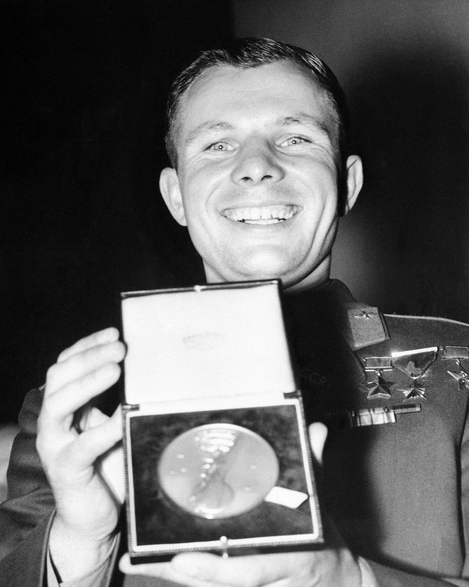 FILE - In this Tuesday, July 11, 1961 file photo, Major Yuri Gagarin, the Russian cosmonaut, holds the gold medal of the British Interplanetary Society after it was awarded to him after his press conference at the Soviet exhibition in Earls Court, London. The successful one-orbit flight on April 12, 1961 made the 27-year-old Gagarin a national hero and cemented Soviet supremacy in space until the United States put a man on the moon more than eight years later. (AP Photo/File)