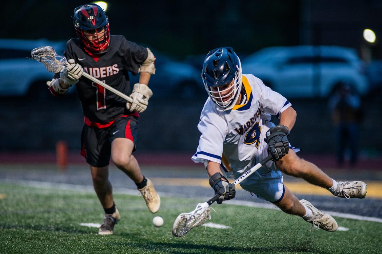 Lourdes' Jake Kannenberg, right, and Red Hook's Adam Jurkowski go after a loose ball during an April 19, 2024 boys lacrosse game.