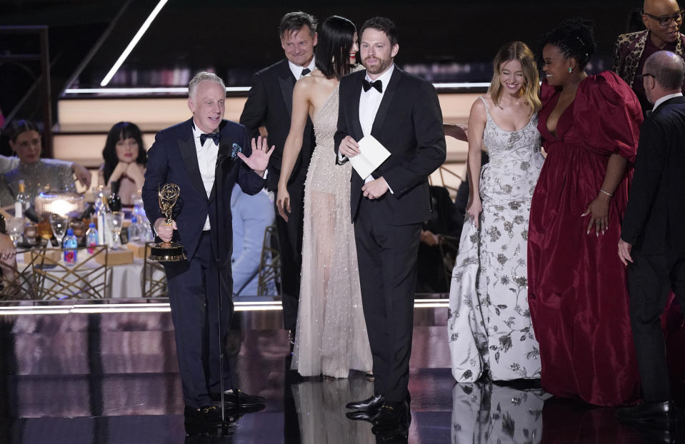 Mike White, from left, Nick Hall and the cast of "The White Lotus" accepts the Emmy for outstanding limited or anthology series at the 74th Primetime Emmy Awards on Monday, Sept. 12, 2022, at the Microsoft Theater in Los Angeles. (AP Photo/Mark Terrill)