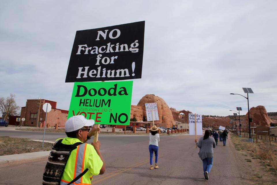 Teec Nos Pos, Arizona resident Anthony Peterson, left, protests a proposal to start helium production in Teec Nos Pos and Sanostee chapters during demonstration on April 18 in Window Rock, Arizona.