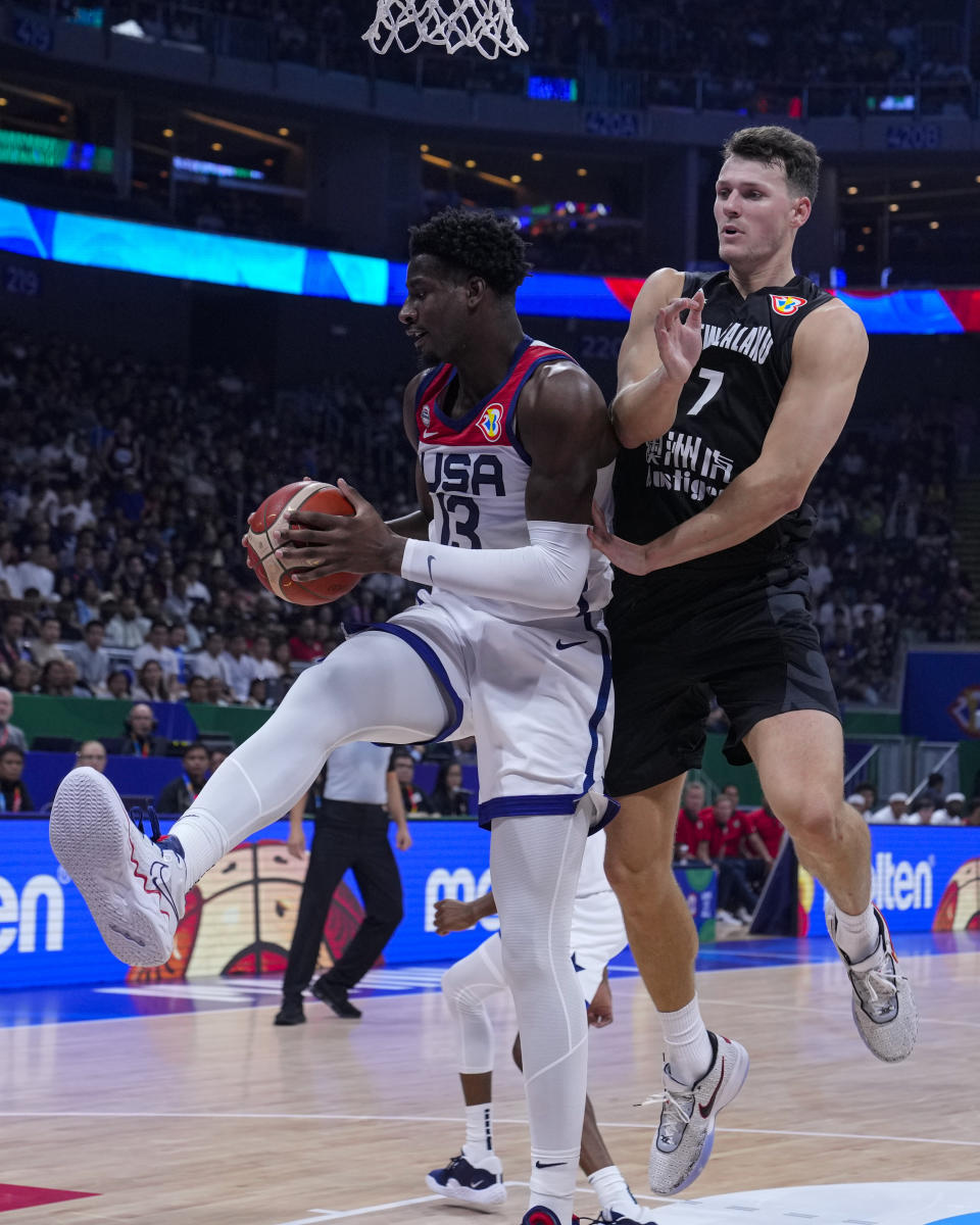 U.S. forward Jaren Jackson Jr. (13) grabs a rebound under New Zealand forward Yannick Wetzell (7) during the first half of a Basketball World Cup group C match in Manila, Saturday, Aug. 26, 2023. (AP Photo/Michael Conroy)