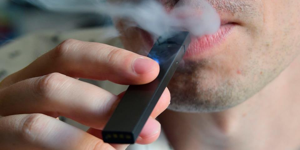 Close-up of a man vaping a Juul.