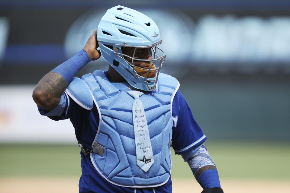 Kansas City Royals' Martin Maldonado walks on the field during a baseball game against the Minnesota Twins, Sunday, June 16, 2019, in Minneapolis. Maldonado celebrated Father's Day by wearing a blue necktie on his chest protector and had three hits to lift the Kansas City Royals over the Minnesota Twins 8-6 on Sunday. (AP Photo/Stacy Bengs)