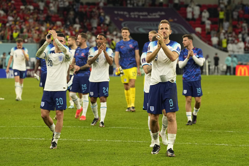 England's Harry Kane, second right, and teammates acknowledge the crowd after their win in the World Cup group B soccer match between England and Wales, at the Ahmad Bin Ali Stadium in Al Rayyan, Qatar, Tuesday, Nov. 29, 2022. (AP Photo/Pavel Golovkin)