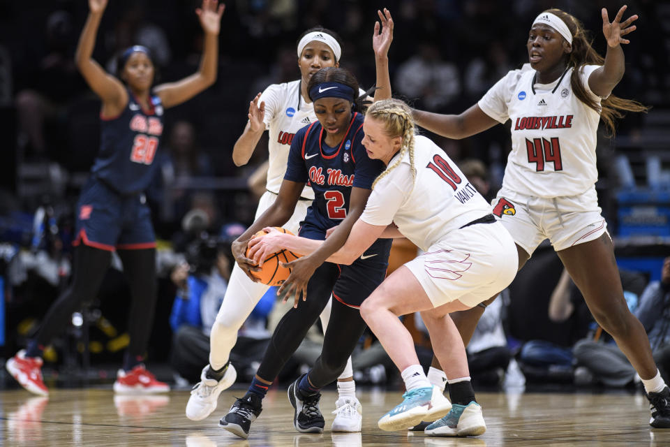 Mississippi guard Marquesha Davis (2) and Louisville guard Hailey Van Lith (10) wrestle for possession of the ball during the first half of a Sweet 16 college basketball game in the women's NCAA Tournament in Seattle, Friday, March 24, 2023. (AP Photo/Caean Couto)