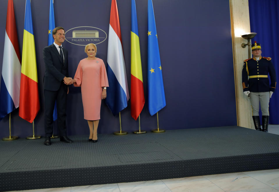 Dutch Prime Minister Mark Rutte, left, shakes hands with his Romanian counterpart Viorica Dancila at the Victoria Palace in Bucharest, Romania, Wednesday, Sept. 12, 2018. Rutte is on a one day official visit to Romania.(AP Photo/Vadim Ghirda)