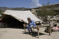 Afghan boy sits in a courtyard of her destroyed home after an earthquake in Gayan district in Paktika province, Afghanistan, Sunday, June 26, 2022. A powerful earthquake struck a rugged, mountainous region of eastern Afghanistan early Wednesday, flattening stone and mud-brick homes in the country's deadliest quake in two decades, the state-run news agency reported. (AP Photo/Ebrahim Nooroozi)