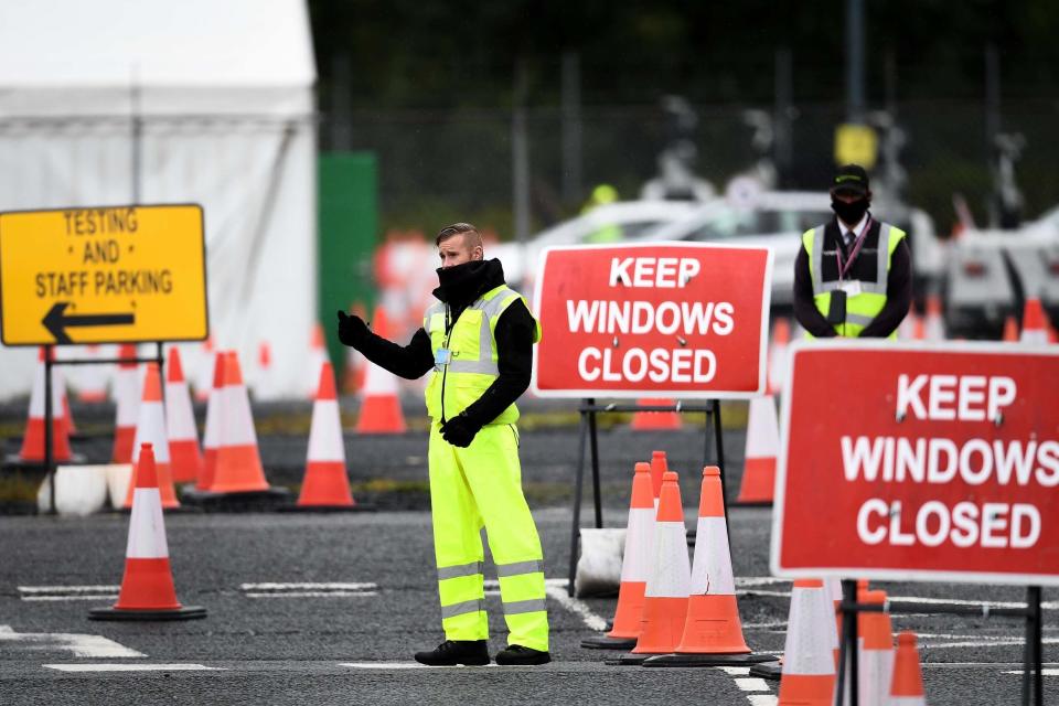 An employee directs members of the public into a coronavirus testing centre at Glasgow Airport (Getty Images)