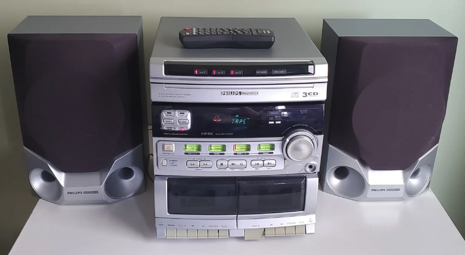 A Philips mini hi-fi audio system with two speakers and a remote control on top of the main unit