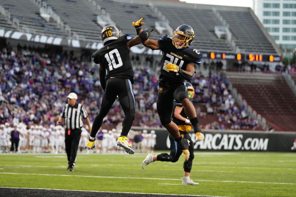 Moeller wide receiver Tennel Bryant (10) celebrates with running back Jordan Marshall (24) as the Crusaders beat Elder 42-14 at Nippert Stadium Friday, Sept. 30.
(Photo: SAM GREENE/THE ENQUIRER)