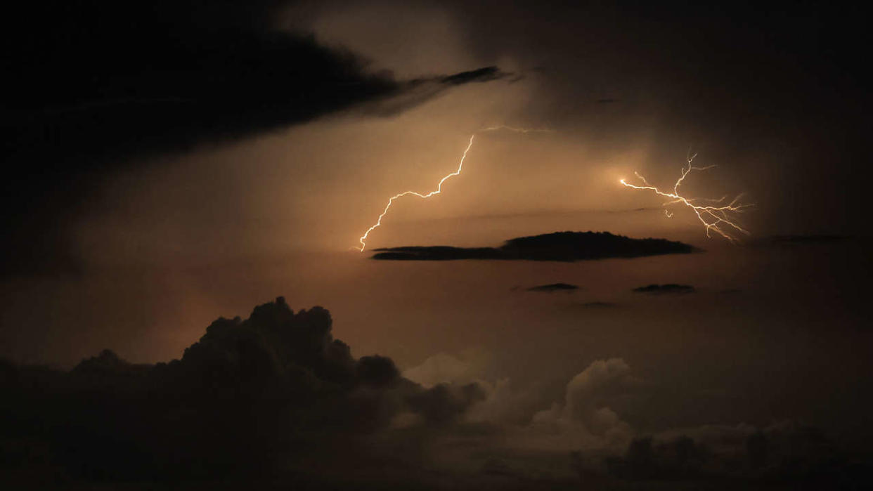 TOPSHOT - A photograph taken from the French riviera city of Nice, shows lightning flashes in a supercell thunderstorm over the Mediterranean sea on the night of August 18 to 19 August 2022. (Photo by Valery HACHE / AFP) (Photo by VALERY HACHE/AFP via Getty Images)