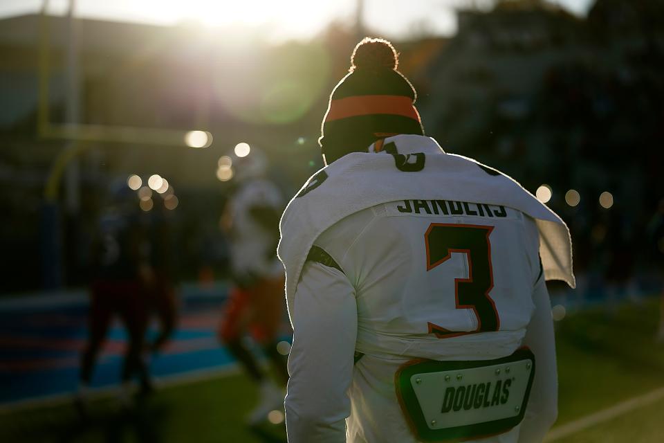 Injured Oklahoma State quarterback Spencer Sanders watches from the sideline during a game against Kansas on Saturday.