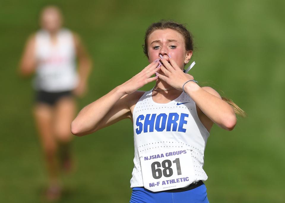 Shore Regional's Megan Donlevie reacts as she crosses the finish line first in the NJSIAA Group 1 race