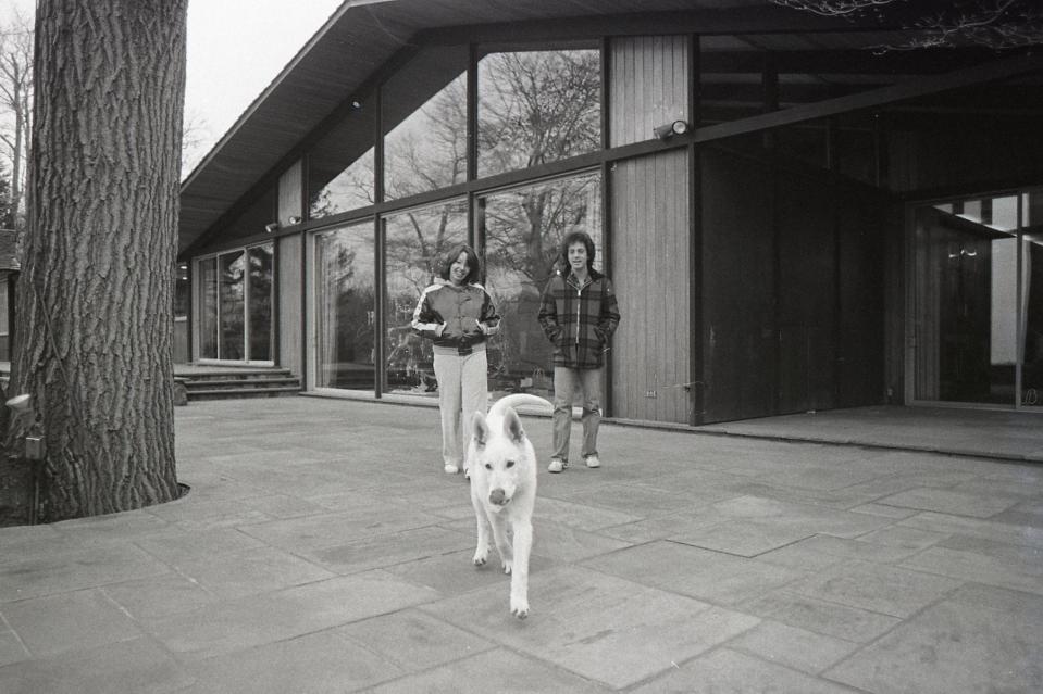 Joel and Weber outside the house that would later be depicted on his album Glass Houses.