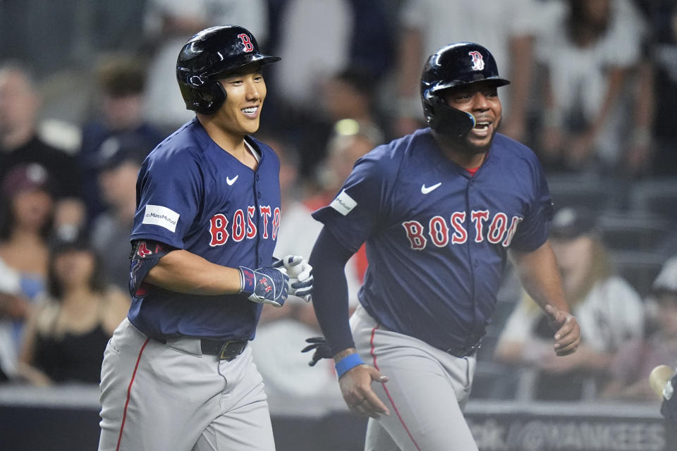 Boston Red Sox's Masataka Yoshida, left, of Japan, and Dominic Smith, right, celebrate after they scored on a two-run home run by Yoshida during the ninth inning of a baseball game against the New York Yankees, Friday, July 5, 2024, in New York. (AP Photo/Frank Franklin II)