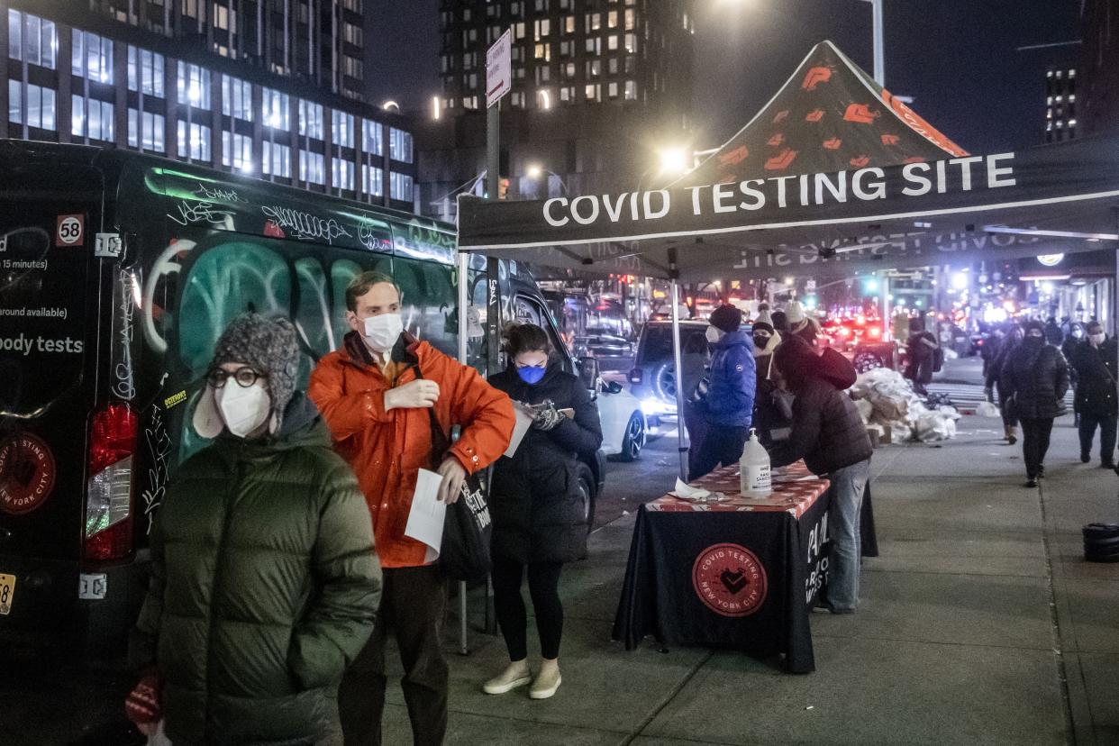 People wait on line to get tested for COVID-19 on the Lower East Side of Manhattan, Tuesday, Dec. 21, in New York. 