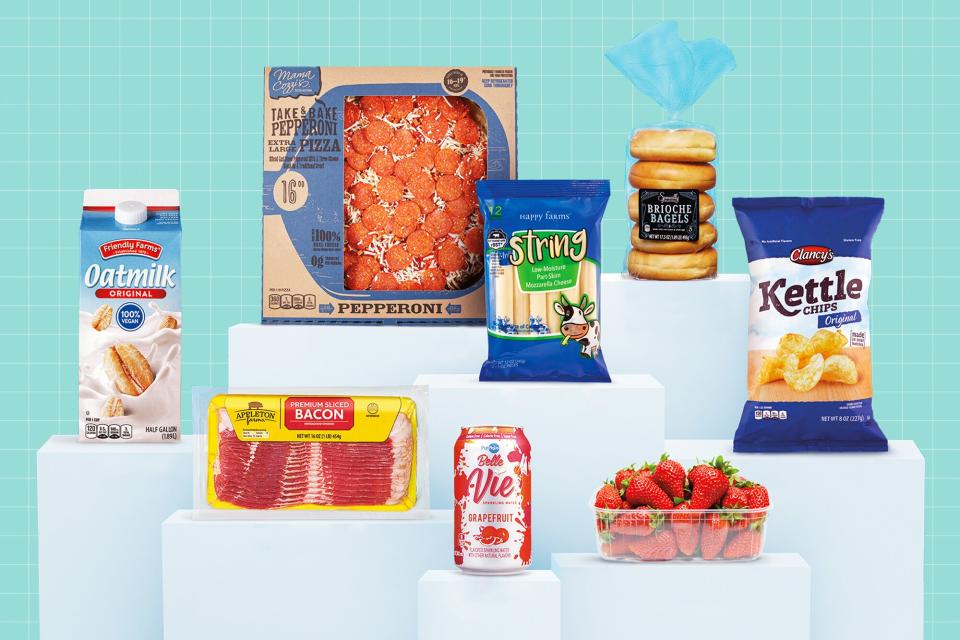 A collection of Aldi food products on pedestals on a designed background